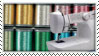 a white sewing machine in front of many different colored spools of thread